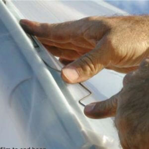 using the wiggle wire to hold the hoop house plastic in place