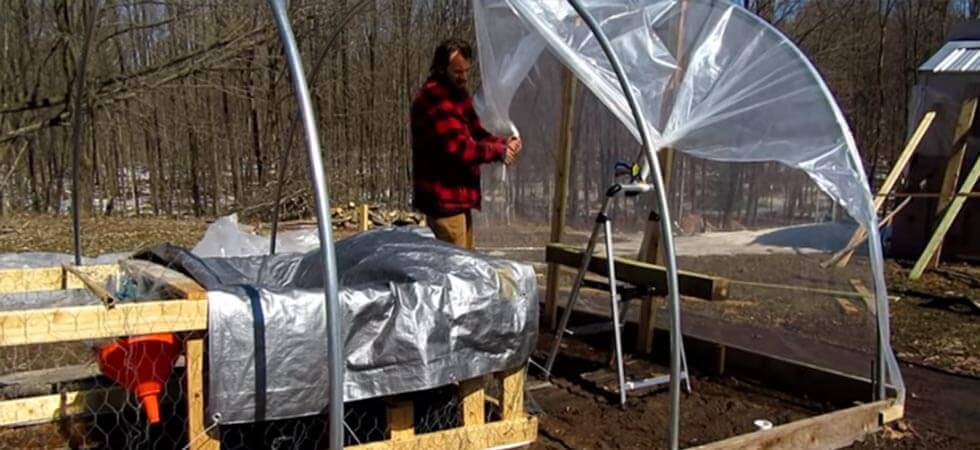 securing the plastic of the hoop house